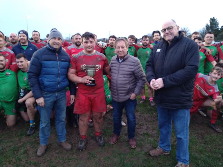 Pembroke skipper Lloyd Davies receives the Jenny Gibby Cup from Jay and Richard Gibby, plus Pembroke president Dillwyn Williams